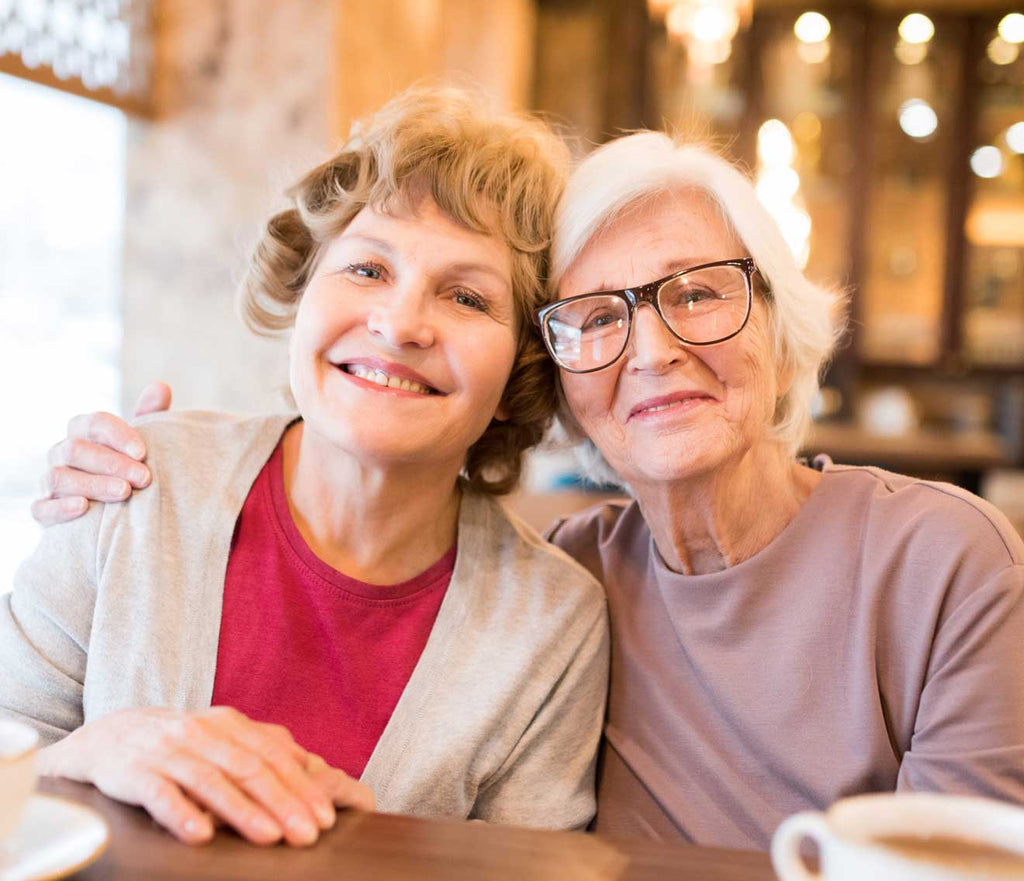 Senior discussing CaregiverCaller medical alert system that calls family with adult daughter caregiver